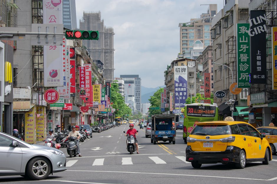 Busy street scene in Taipei, Taiwan featuring traffic, buildings, and vibrant city life.