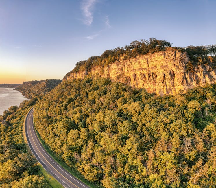 Breathtaking aerial view of a winding road along a cliff with lush greenery, near Stockholm, Wisconsin.